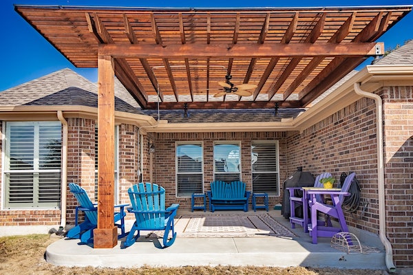 Cedar pergola with string lights at night